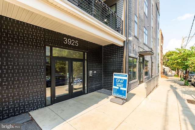 entrance to property featuring french doors and a balcony