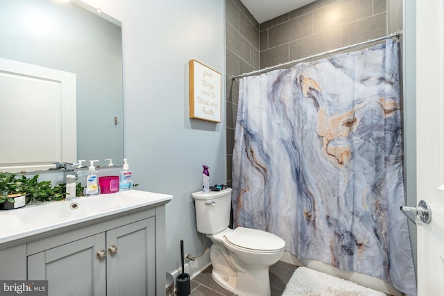 bathroom with vanity, a shower with shower curtain, toilet, and tile patterned flooring