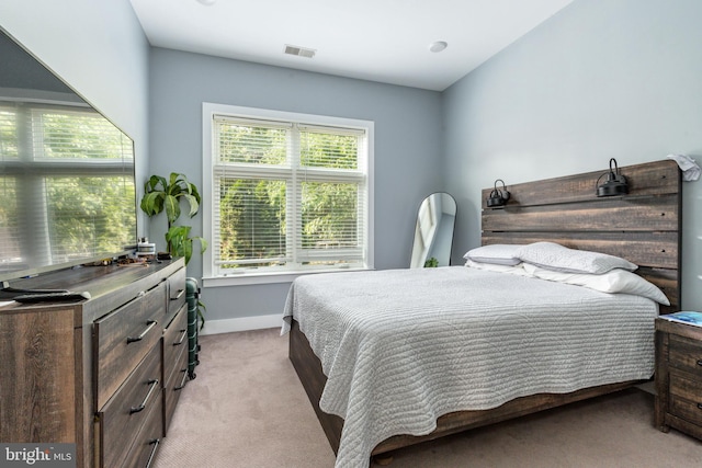 bedroom with light colored carpet