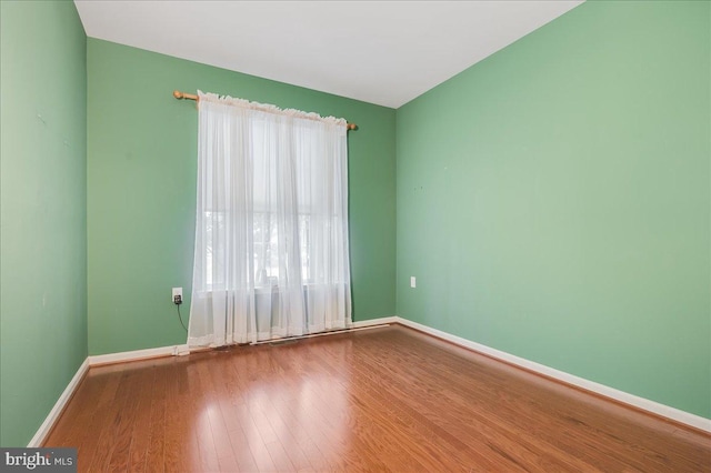 spare room with hardwood / wood-style flooring