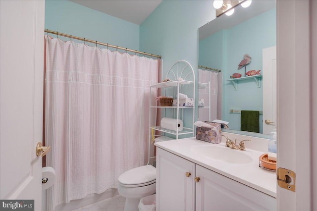 bathroom featuring vanity, toilet, tile patterned floors, and walk in shower