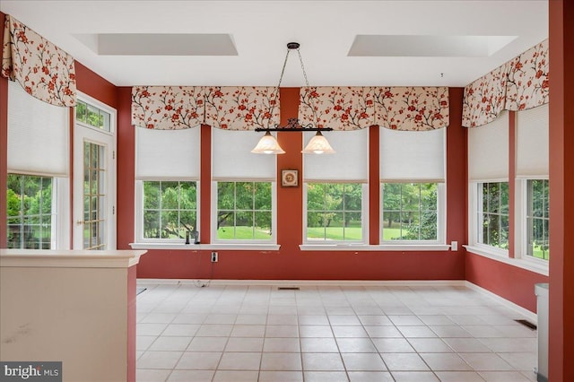 unfurnished dining area featuring a wealth of natural light and light tile patterned floors