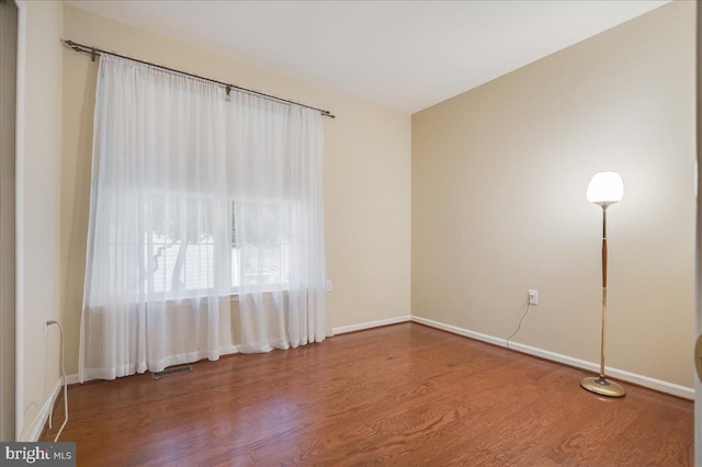 spare room with hardwood / wood-style floors