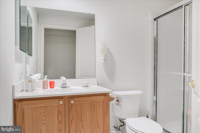 bathroom with toilet, walk in shower, and vanity