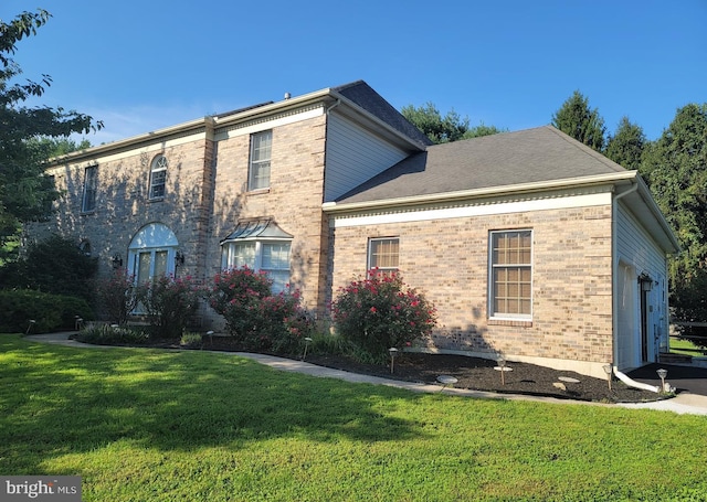 view of front of house featuring a garage and a front lawn