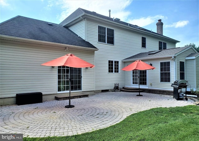 back of property with a patio