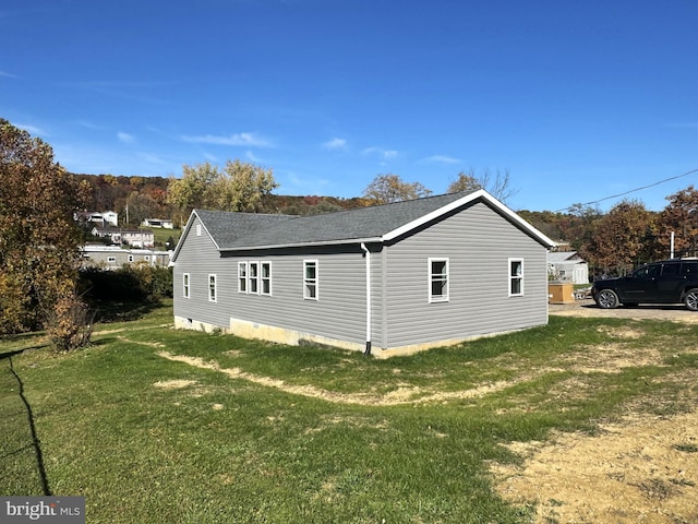 view of property exterior featuring a lawn