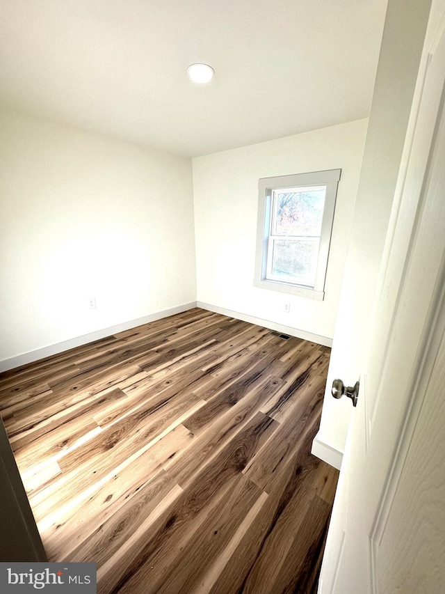 empty room featuring hardwood / wood-style flooring