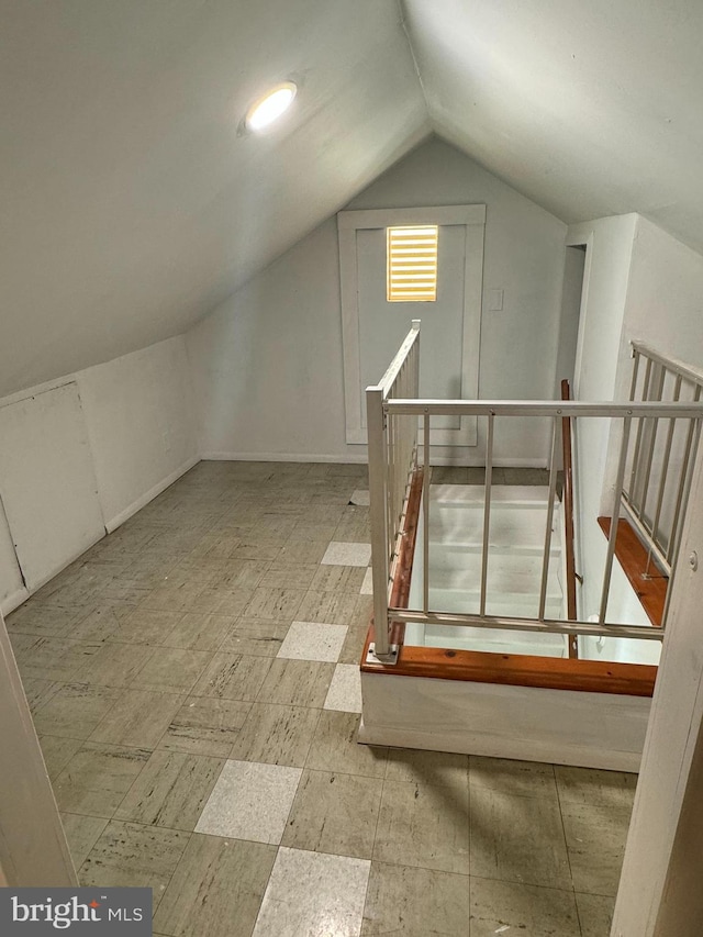 additional living space featuring lofted ceiling