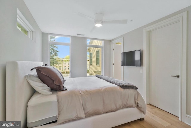 bedroom with light wood-type flooring and ceiling fan