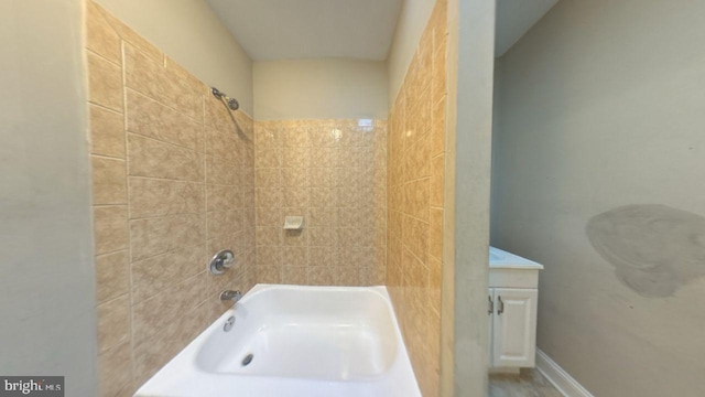 bathroom featuring vanity and tiled shower / bath combo