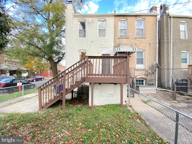 rear view of property featuring a deck