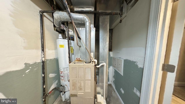 utility room featuring water heater