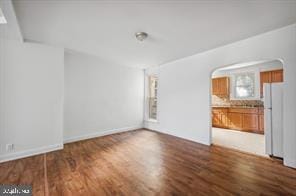 empty room with dark hardwood / wood-style floors