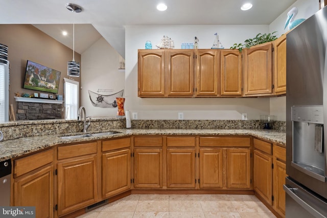 kitchen with light stone counters, sink, light tile patterned floors, and appliances with stainless steel finishes