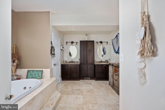 bathroom with vanity and tiled tub