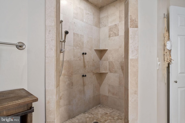 bathroom with a tile shower