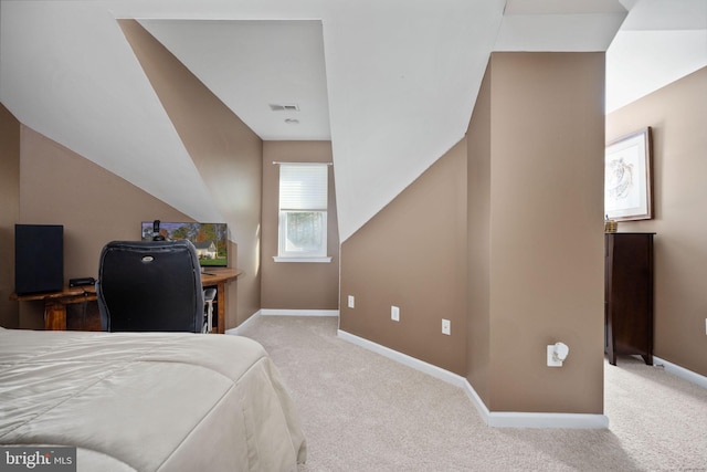 bedroom with vaulted ceiling and light colored carpet