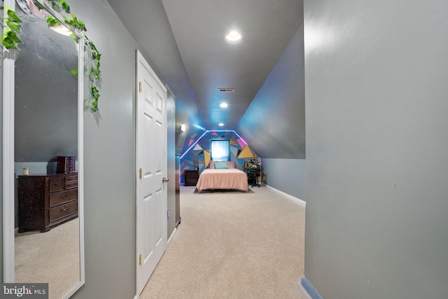 bedroom featuring lofted ceiling and light carpet