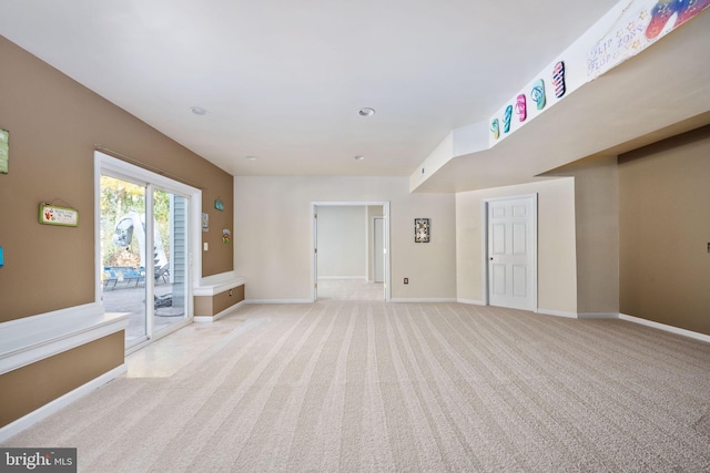 unfurnished living room featuring light colored carpet