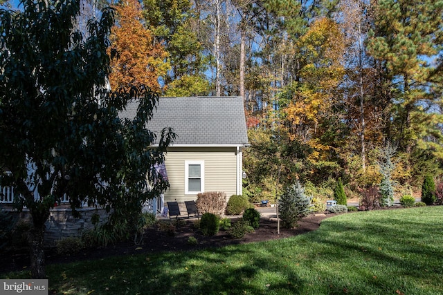 view of side of home featuring a yard