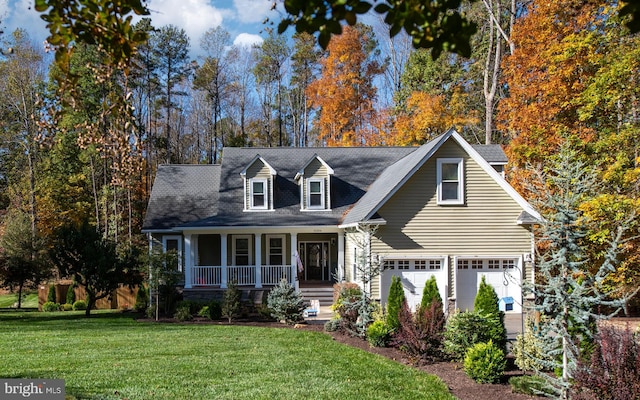 cape cod house featuring a garage, a front yard, and covered porch