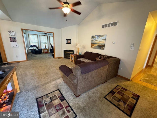 living room featuring light colored carpet, high vaulted ceiling, and ceiling fan