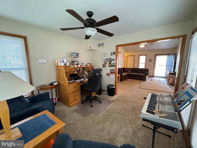 carpeted office with ceiling fan