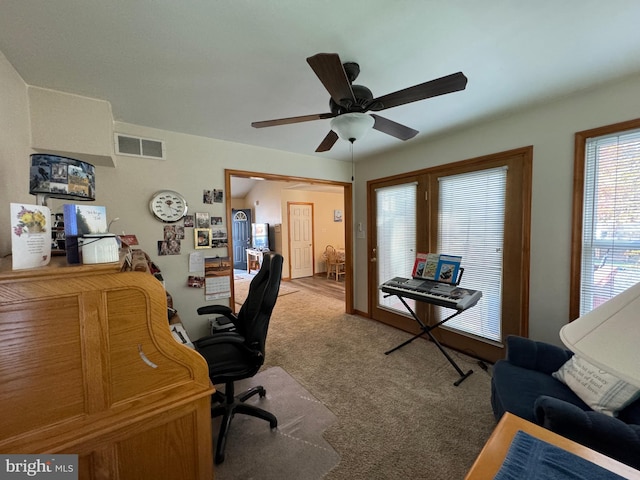 home office with ceiling fan and carpet flooring