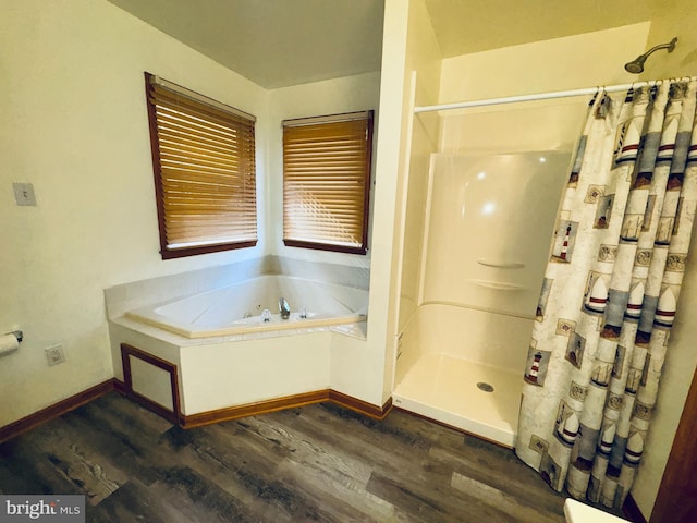 bathroom featuring independent shower and bath and hardwood / wood-style flooring