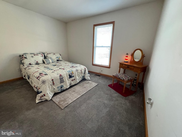 bedroom featuring dark carpet