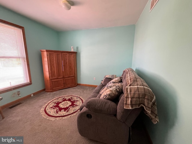 living area featuring light carpet