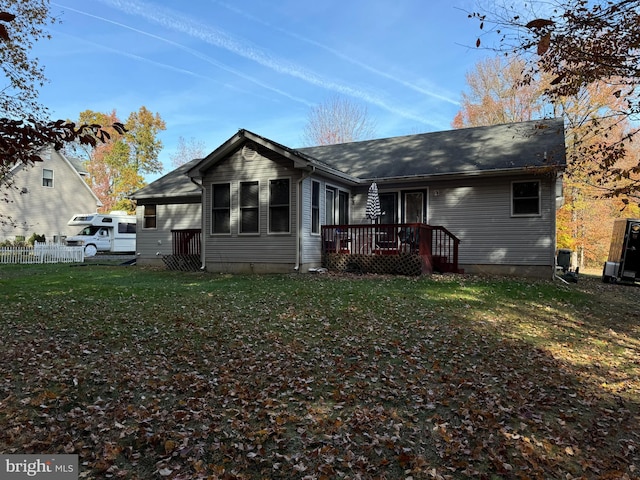 rear view of house featuring a yard