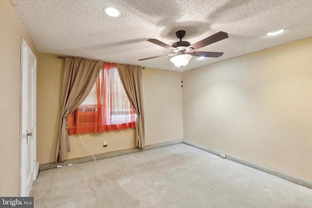 carpeted empty room featuring a textured ceiling and ceiling fan