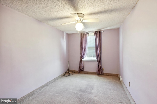 spare room with ceiling fan and a textured ceiling