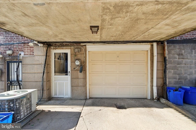 doorway to property featuring central air condition unit and a garage