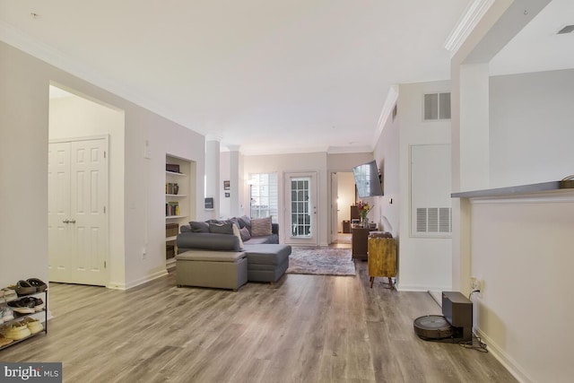 living room featuring light hardwood / wood-style flooring and ornamental molding