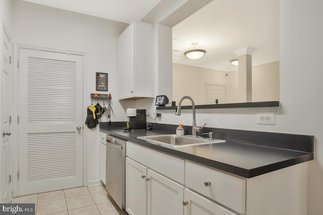 kitchen featuring stainless steel dishwasher, sink, white cabinetry, and light tile patterned floors