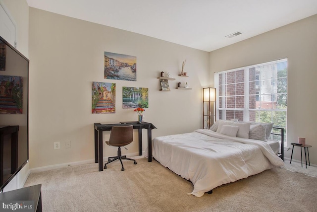 bedroom with light colored carpet