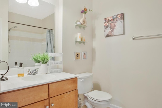 bathroom featuring vanity, toilet, and a shower with shower curtain