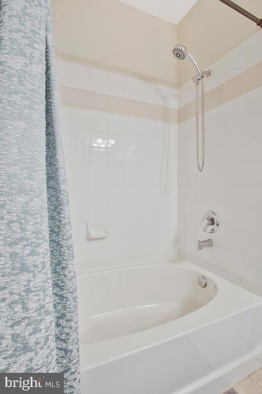 bathroom with shower / bath combo with shower curtain