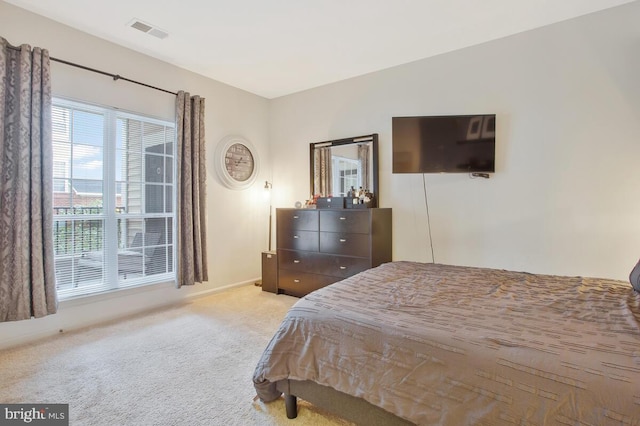 bedroom featuring light colored carpet