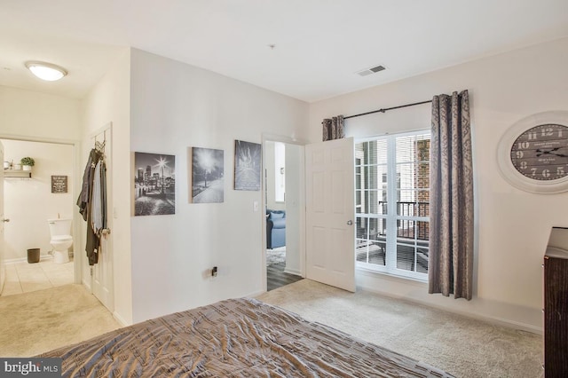 bedroom featuring light carpet and ensuite bathroom