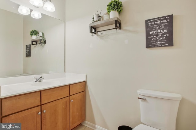 bathroom with toilet and vanity