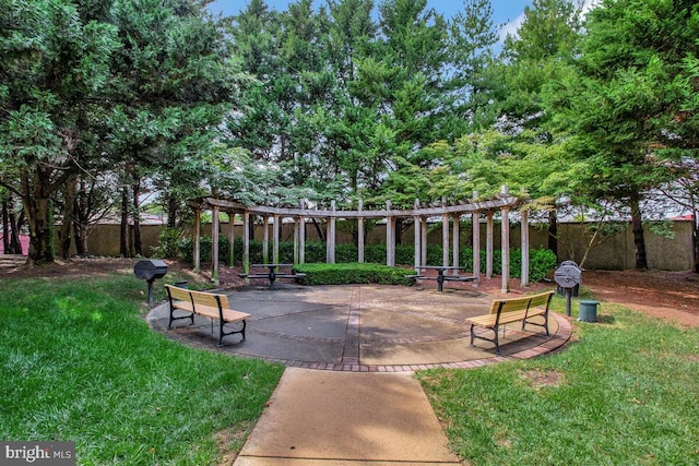 surrounding community featuring a yard, a patio, and an outdoor fire pit