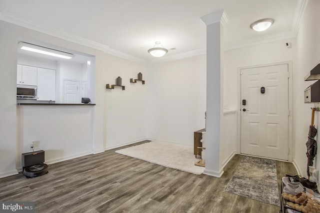 foyer featuring ornamental molding and dark hardwood / wood-style floors