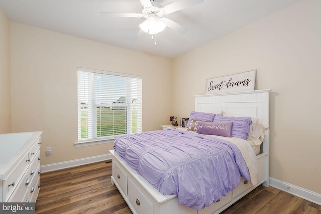 bedroom with dark hardwood / wood-style floors and ceiling fan