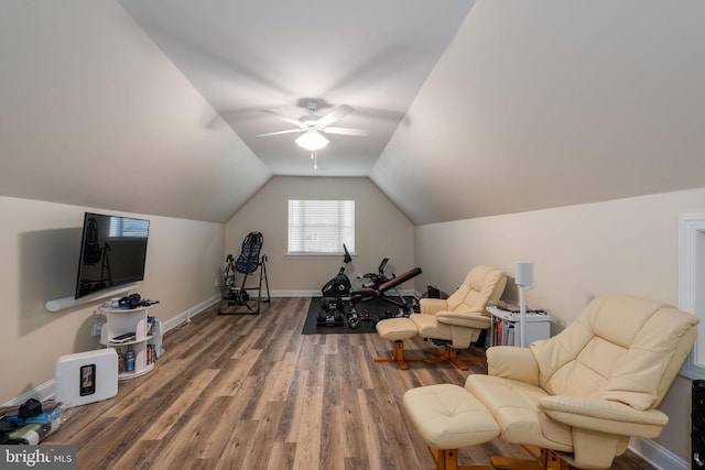 exercise room with lofted ceiling, wood-type flooring, and ceiling fan