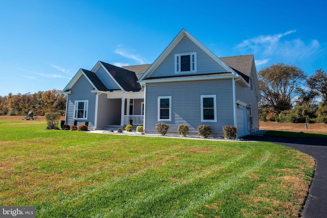 exterior space with a lawn, a garage, and a porch