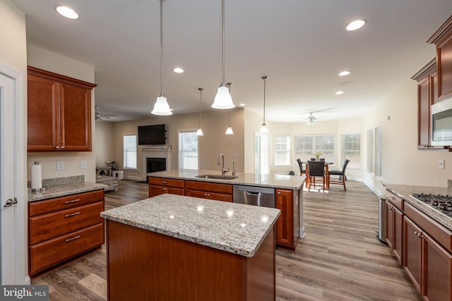 kitchen featuring a healthy amount of sunlight, sink, pendant lighting, and a kitchen island